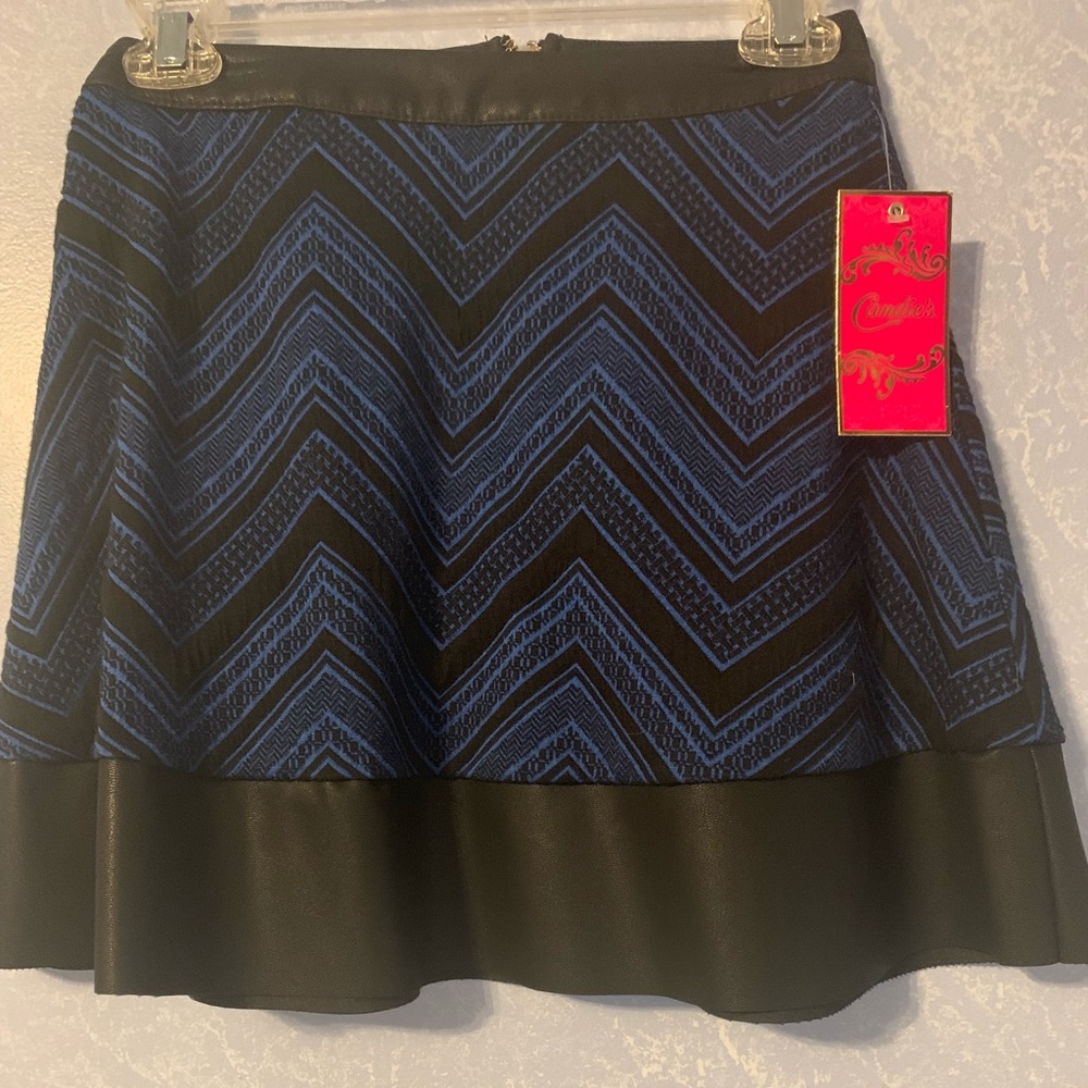 A blue mini skirt with black faux leather trim.